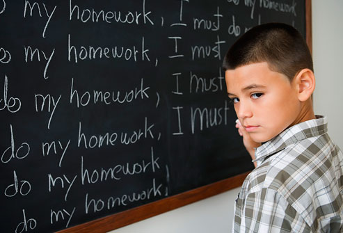 getty_rf_photo_of_boy_writing_on_blockboard